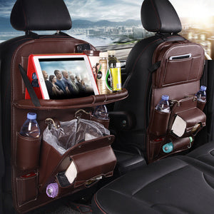 Coffee color road trip seat-back organizer with folding tray and storage pockets installed in car