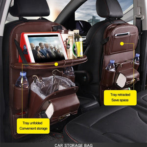 Brown PU-leather seat-back organizer showing the tray unfolded for storage on one seat and folded up to save space on the other.
