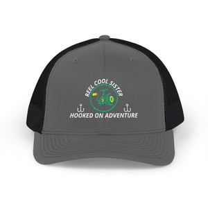 Reel Cool Sister embroidered trucker cap, front view, charcoal front with black mesh back